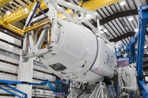 Dragon spacecraft being attached to Falcon 9 in prep for flight