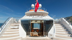 Twin staircases wrap the beach club featuring curved glass doors